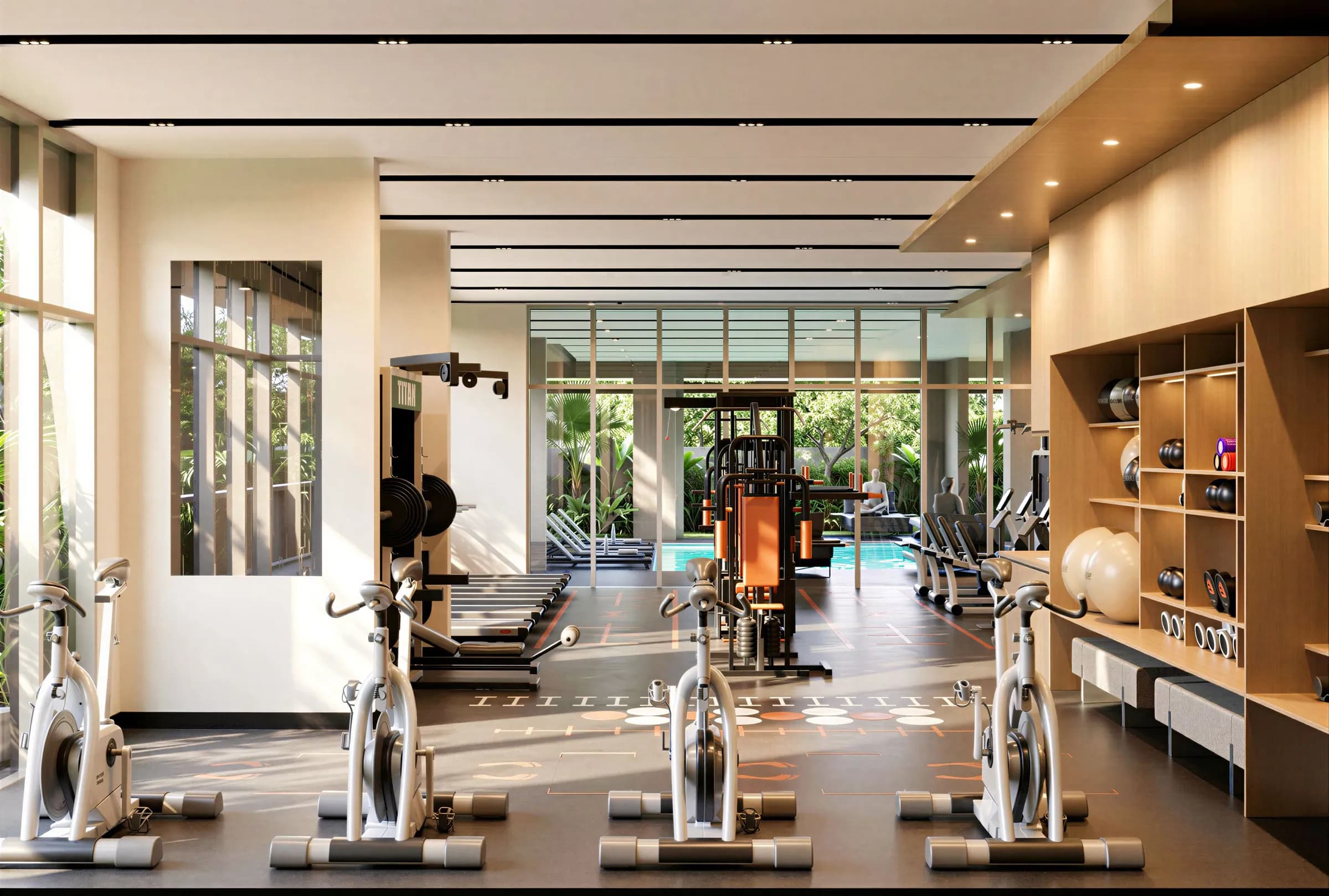 A gym with spin bikes, weights and a view of greenery and the pool