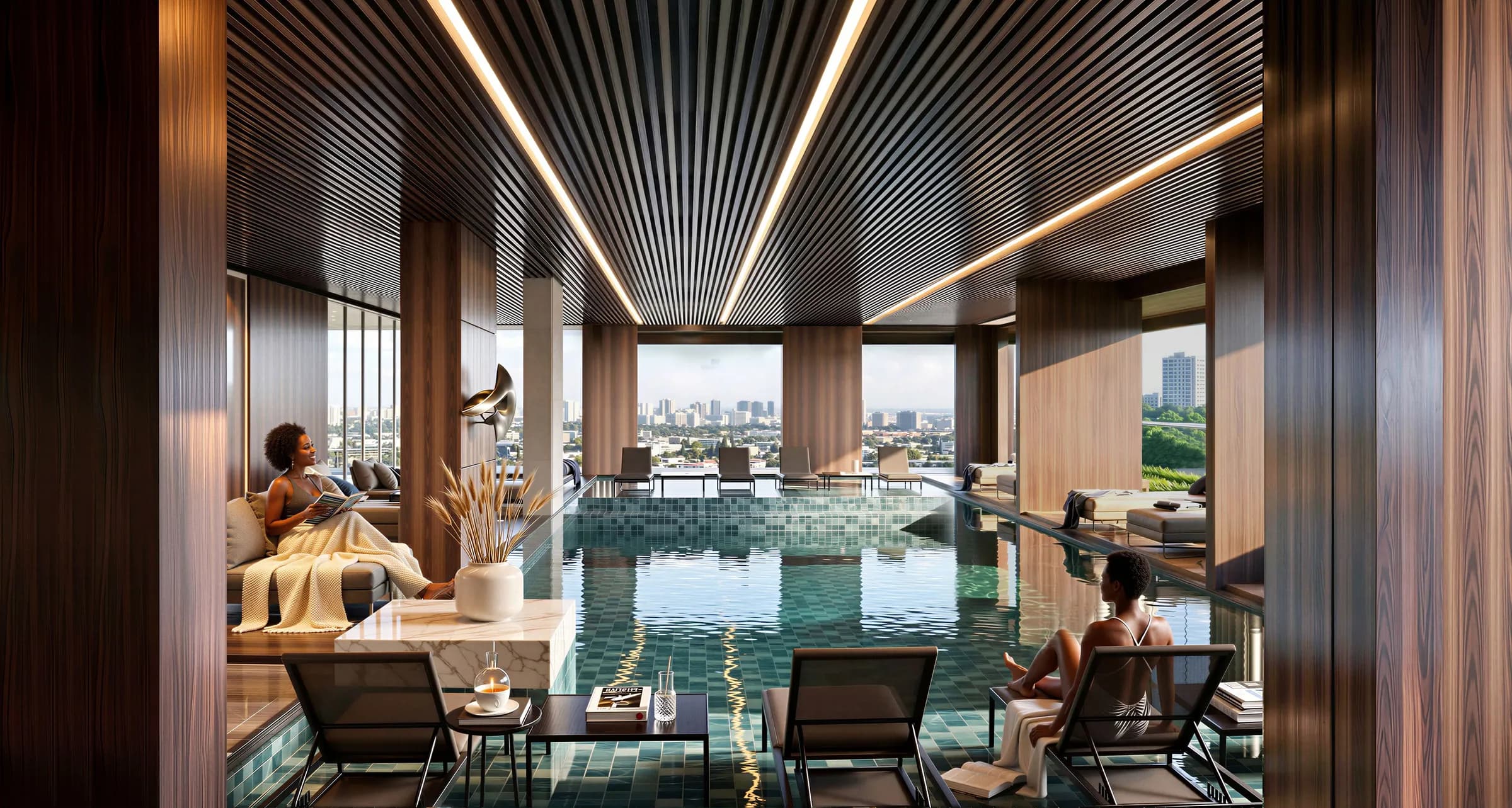 A covered pool with lounge chairs and city views through the openings