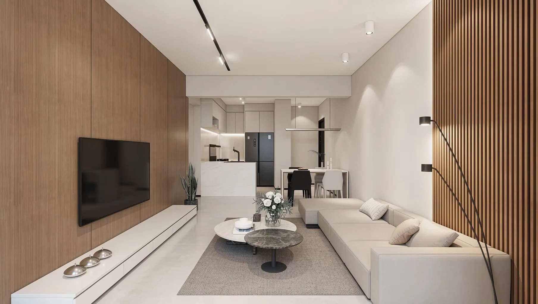 An open-plan living room with a cream sofa, timber wall panelling and a kitchen beyond